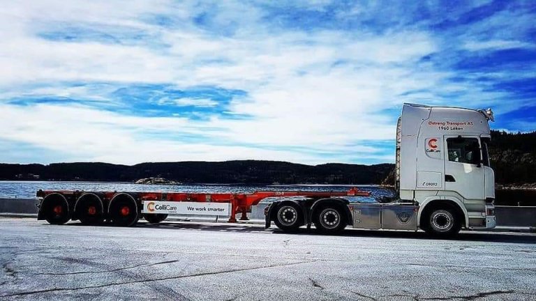 A branded ColliCare truck on the road by the ocean in Norway